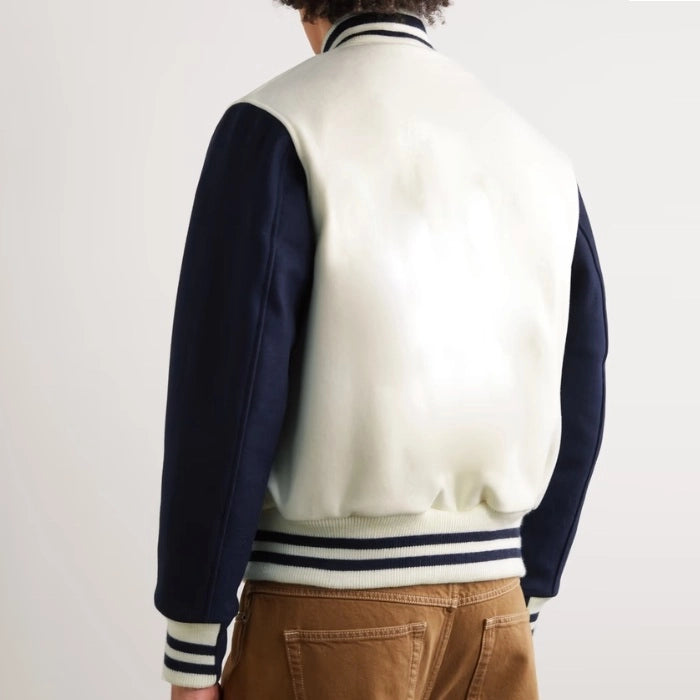 Back view of model wearing a white and navy varsity jacket