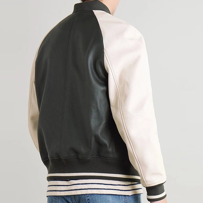 Back view of black and cream leather varsity jacket highlighting its paneled design and striped hem.