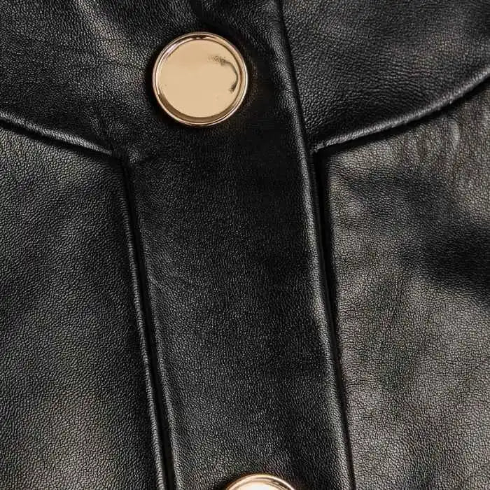 Close-up detail of gold buttons and lambskin texture on Sierra cropped jacket