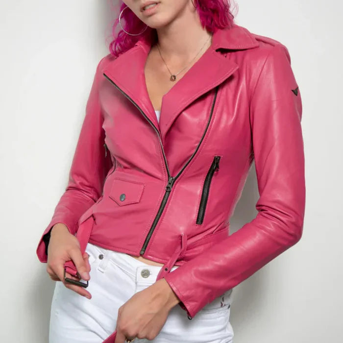 A person wearing a Barbie Pink Cropped Leather Jacket with a classic lapel collar and asymmetrical front zipper closure. The jacket is pink, and the person is also wearing white pants.