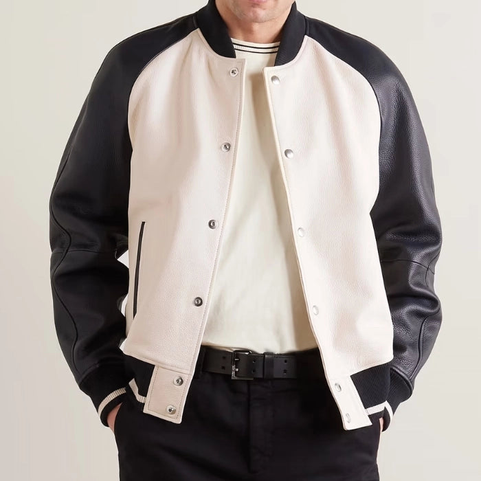Front view of men's beige varsity jacket with black leather sleeves and snap button closure.