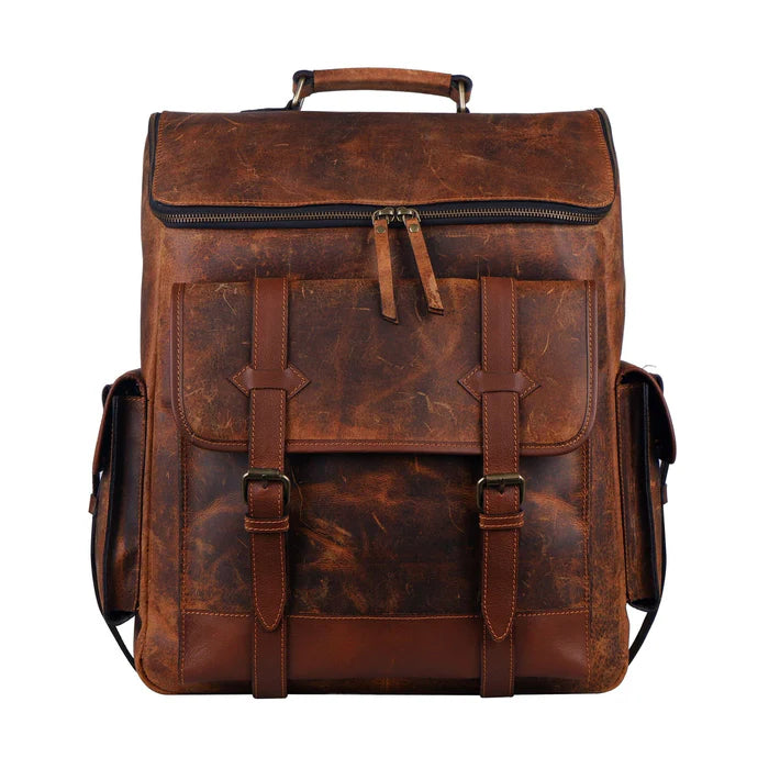 A vintage-style brown full-grain leather backpack with adjustable shoulder straps, side buckle pockets, and a top handle.