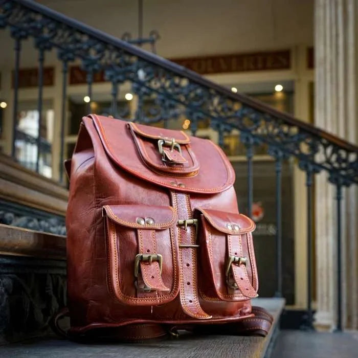 Brown leather backpack on a staircase with a blurred indoor background