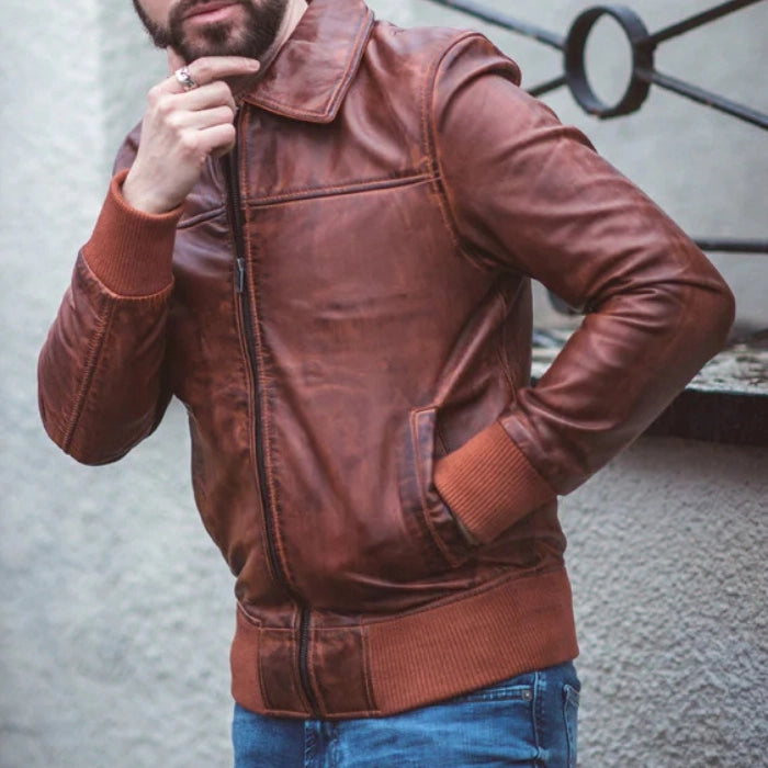 Model wearing a brown zipper vintage bomber leather jacket, showcasing the classic collar, front zipper, and ribbed cuffs in a stylish streetwear look